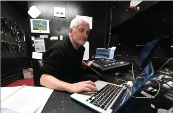  ??  ?? The lighting wizard. Award winning technician John Hurley in his sound and lighting control booth above the auditorium.