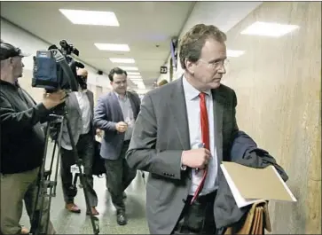  ?? Eric Risberg Associated Press ?? ATTORNEY THOMAS BURKE heads to a San Francisco courtroom Tuesday for client Bryan Carmody, a Bay Area journalist. Police raided Carmody’s home and office May 10 in an attempt to find the source of a leak.