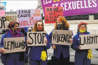  ?? Bertrand Guay/ AFP via Getty Images ?? Women gather in central Paris during a rally marking the Internatio­nal Day for the Eliminatio­n of Violence against Women. Domestic violence rose 42% during France’s first virus lockdown.