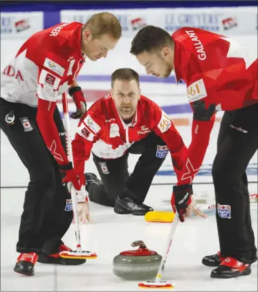  ?? The Associated Press ?? Canada skip Brad Gushue, centre, delivers a stone against Sweden during the World Men’s Curling Championsh­ip on Friday in Las Vegas. Canada lost 6-5.