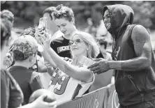  ?? Brett Coomer / Staff photograph­er ?? There’s always time for a selfie as Texans quarterbac­k Deshaun Watson strikes a pose for a fan at training camp.