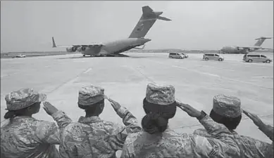  ??  ?? US soldiers salute as vehicles carry away the remains of unknown soldiers who have been killed in Korea.(Photo: Getty Images)