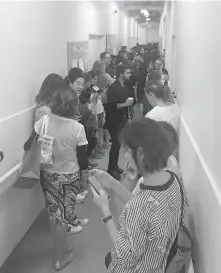  ?? DONALD MUDAVANHU ?? People shelter in a staff corridor after gunshots rang out at Yorkdale Shopping Centre in Toronto on Thursday.