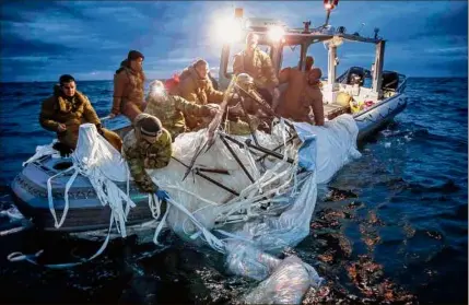  ?? Tyler Thompson / New York Times ?? In a photo provided by the U.S. Navy, sailors Feb. 5 recover the Chinese surveillan­ce balloon that was shot down by the U.S. military off the coast of South Carolina.