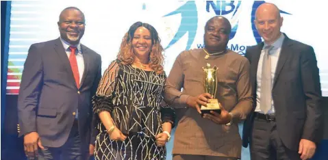  ??  ?? Sales Director, Nigerian Breweries Plc, Uche Unigwe; Mrs Ken Maduakor; Chairman, Ken Maduakor Group Limited and winner, National Champions Award /2017 Best Distributo­r, Ken Madualor and Managing Director, Nigerian Breweries Plc, Jordi Borrut Bel at the...