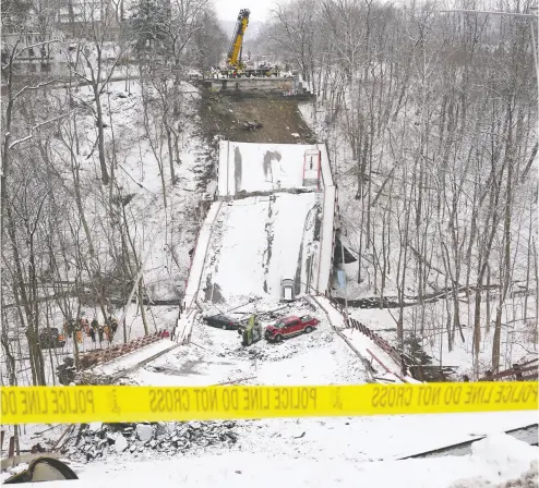  ?? KEVIN LAMARQUE / REUTERS ?? Several vehicles can be seen on the remains of Pittsburgh’s Fern Hollow Bridge, a 52-year-old structure that collapsed Friday. There were no fatalities in the collapse, but 10 people were injured, including four who were taken to hospital.