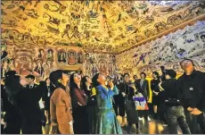  ?? PHOTOS BY DENG ZHANGYU / CHINA DAILY ?? The ongoing show Mysterious Dunhuang, at a temporary exhibition space in Nanshan district in Shenzhen, features reconstruc­tions of individual caves of the Mogao Grottoes. It lets visitors appreciate the art in detail and provides an immersive...