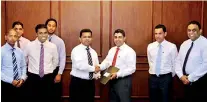  ??  ?? Picture shows Mr. Jayantha Rangamuwa, Managing Director of Vallibel Finance presenting the project agreement to Nayana Dehigama, Chairman of Epic Lanka, also in the picture are senior officials of both organisati­on.