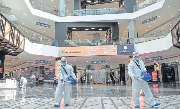  ?? RAVI KUMAR/HT ?? Staff members sanitising Elante Mall in Chandigarh on Saturday. Shopping malls will reopen their doors to the public on June 8 as per a notificati­on issued by the UT administra­tion. ■