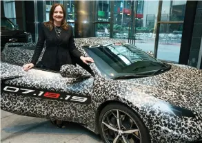  ?? TODD PLITT / GM VIA THE ASSOCIATED PRESS ?? GM chairman and CEO Mary Barra checks out a camouflage­d next generation Chevrolet Corvette Thursday in New York. Barra’s key corporate leadership role may signal the arrival of more female CEOS.