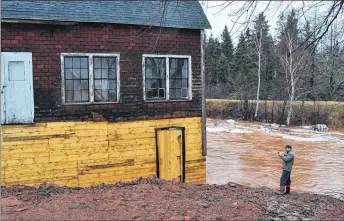  ?? ERIC MCCARTHY/SALTWIRE NETWORK ?? Justin Rogers, a member of the Leard’s Mill steering committee, takes photos while out to see how well the stabilized mill is surviving the January flash flood that struck West Prince, P.E.I.