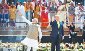  ??  ?? India Prime Minister Narendra Modi and U.S. President Donald Trump wave during a “Namaste Trump” rally Monday on the outskirts of Ahmedabad, India.