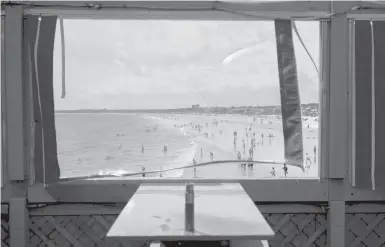  ?? TRISTAN SPINSKI/THE NEW YORK TIMES ?? A view from the pier at Old Orchard Beach, Maine. A sharp drop this summer in the number of foreign seasonal workers in the town has forced some businesses that rely on tourism to limit their hours.