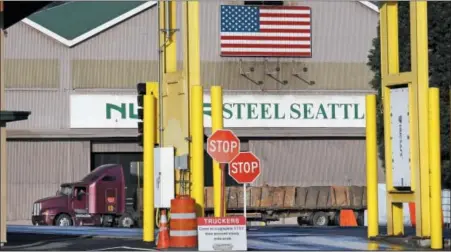  ?? AP PHOTO/ELAINE THOMPSON, FILE ?? In this Feb. 25, 2016 file photo, a truck carries a load at the Nucor Steel plant in Seattle. U.S. companies pursuing exemptions from President Donald Trump’s tariff on imported steel are accusing American steel manufactur­ers of spreading inaccurate and misleading informatio­n, and they fear it may torpedo their requests. The president of one company calls objections raised by U.S. Steel and Nucor to his waiver request “literal untruths.”