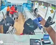  ?? Photo / Alex Burton ?? Left: Police at the Northwest Shopping Centre Massey after armed robbers raided the Michael Hill Jeweller store. Above: CCTV footage of the robbery.