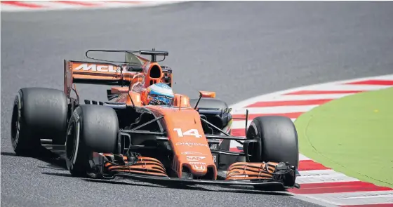  ??  ?? McLaren driver Fernando Alonso steers his car during Friday’s practice.