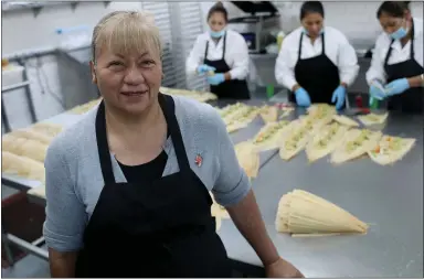  ?? PHOTOS BY ANDA CHU — STAFF ?? Alicia Villanueva, at her 6,000-square-foot production facility in Hayward, started selling homemade tamales door-to-door and now has a contract with Chase Center. She has also supplied Google, Facebook and Twitter cafeterias.
