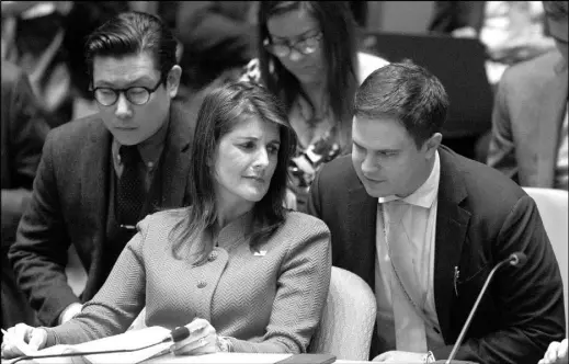  ?? MARY ALTAFFER / AP ?? U.S. Ambassador Nikki Haley speaks to aides before a Security Council meeting April 18 at United Nations headquarte­rs.