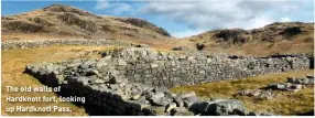  ??  ?? The old walls of Hardknott fort, looking up Hardknott Pass.