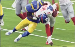  ?? John Cordes / Associated Press ?? Giants quarterbac­k Daniel Jones (8) is tackled by the Rams’ Leonard Floyd on Sunday.