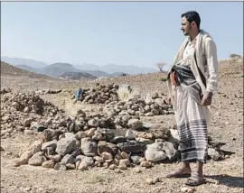  ?? Sam Tarling Sana Center f or Strateg i c Studies ?? AHMAD DABISI, a human smuggler, has had to bury eight clients at this graveyard outside Ataq, Yemen. They had left East Africa in search of better lives.