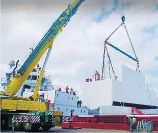  ??  ?? A fabricated module being installed by Dales Marine workers.