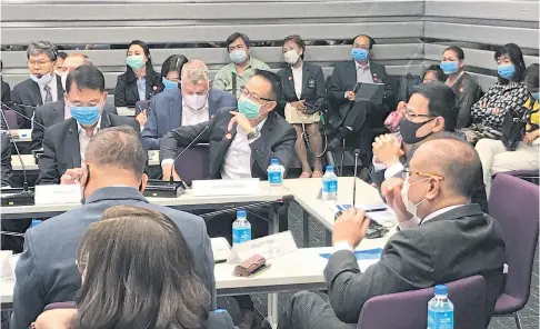  ??  ?? A meeting at the Office of the Insurance Commission sees all participan­ts wearing masks as a precaution as many insurers offer Covid-19 products.