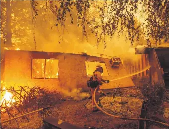  ?? AFP ?? A fast, late-season wildfire in northern California burnt tens of thousands of hectares of land and forced the authoritie­s to order thousands of people to leave their homes