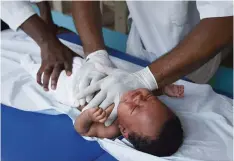  ??  ?? ABIDJAN: Medical staff treat a child for breathing problems using physical therapy on March 17, 2016 during tests to diagnose pneumonia for children until age five in a health centre in the Attecoube neighborho­od. —AFP