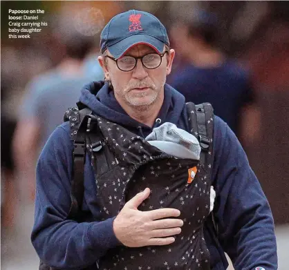  ??  ?? Papoose on the loose: Daniel Craig carrying his baby daughter this week