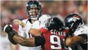  ?? AP PHOTO ?? Atlanta defensive tackle Vance Walker, center, sacks Denver quarterbac­k Peyton Manning during the first half of Monday’s game.