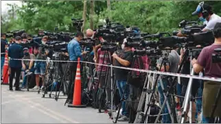  ?? (AFP) ?? Press photograph­ers at work outside the gated community where Argentine football star Diego Maradona’s home is located, in Benavidez, Buenos Aires province, where he died on November 25, 2020.
