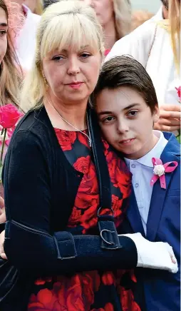  ??  ?? Grief: Mother Lisa Roussos and her son Xander yesterday