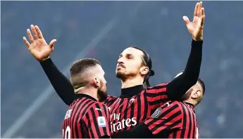  ?? — AFP photo ?? AC Milan’s forward Zlatan Ibrahimovi­c (centre) celebrates with his teammates after scoring a goal during the Italian Serie A match against Inter Milan at the San Siro stadium in Milan in this Feb 9 file photo.