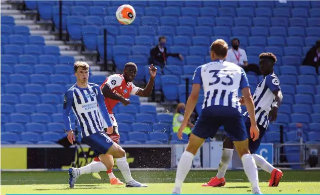  ?? —AFP ?? BRIGHTON: Arsenal’s French-born Ivorian midfielder Nicolas Pepe (2L) scores the opening goal during the English Premier League football match between Brighton and Hove Albion and Arsenal at the American Express Community Stadium in Brighton, southern England.