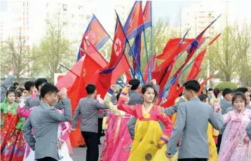  ?? — AFP ?? Youth and students holding a dance party to celebrate the 106th birth anniversar­y of late North Korean leader Kim IlSung in Pyongyang