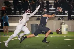  ?? Staff photo by Evan Lewis ?? Pleasant Grove wide receiver Aaron Harmon can’t quite get his hands on the deep ball as Atlanta defensive back Desmond Webster closes in during Friday district game in Texarkana. The Hawks beat the Rabbits, 48-17.