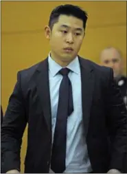  ?? THE ASSOCIATED PRESS ?? New York City Police Officer Peter Liang appears during closing arguments in his manslaught­er trial Tuesday at Supreme Court in Brooklyn. The rookie police officer who shot an unarmed man in a dark public housing stairwell says what happened was a...