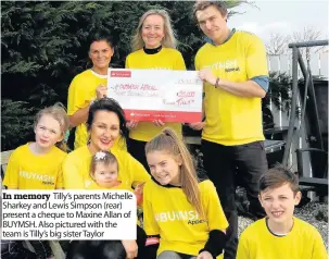  ??  ?? In memory Tilly’s parents Michelle Sharkey and Lewis Simpson ( rear) present a cheque to Maxine Allan of BUYMSH. Also pictured with the team is Tilly’s big sister Taylor