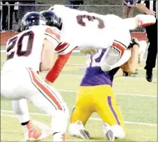  ?? PHOTO BY RICK PECK ?? McDonald County quarterbac­k Peyton Barton gets tackled as he tries to hurdle Monett’s Aaron Howard despite a block from Jake Will during the Mustangs 35-0 loss to Monett on Sept. 30 at Monett High School.