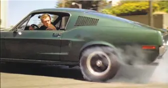  ?? Warner Bros. Pictures 1968 ?? Steve McQueen puts his 1968 Ford Mustang in reverse on the streets of S.F. in “Bullitt.”