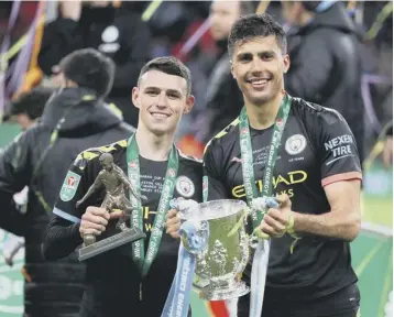  ??  ?? 0 Man of the match Phil Foden, left, and goalscorer Rodri celebrate their victory over Aston Villa.