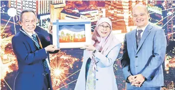  ??  ?? Deputy Prime Minister Datuk Seri Dr Wan Azizah Wan Ismail (middle) receives a token of appreciati­on from Samsudin (left) after delivering her speech at the Internatio­nal Social Security Conference 2018 yesterday. Also present was EPF chief executive officer Datuk Shahril Ridza Ridzuan. — Bernama photo