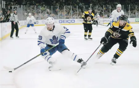  ?? THE ASSOCIATED PRESS ?? Toronto right wing William Nylander controls the puck ahead of Boston Bruins defenceman Matt Grzelcyk.