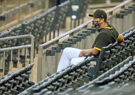  ?? Matt Freed/Post-Gazette photos ?? Pitcher Derek Holland — properly distanced — watches the exhibition game Saturday night from the right-field seats at PNC Park.