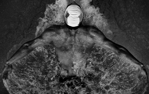  ??  ?? Above: Black and white is sometimes more powerful. For this shot of Michael Phelps, Joel shot from the diving board above the pool.