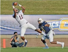  ?? PHOTO BY MARK GILLILAND ?? UT-Martin’s Caylon Weathers scores on a short pass in a 21-7 victory over UTC on Saturday at Finley Stadium.