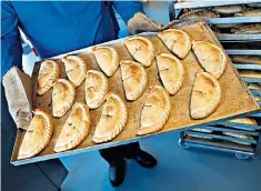  ??  ?? Proper job: a tray of freshly baked traditiona­l Cornish pasties in St Columb Major