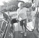  ??  ?? Margie Garrabrand of Wilmington, N.C., tops off her tank Wednesday. KEN RUINARD/ANDERSON INDEPENDEN­T MAIL