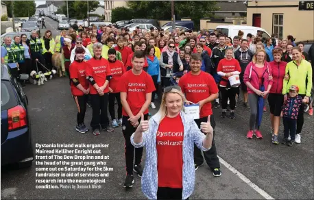  ?? Photos by Domnick Walsh ?? Dystonia Ireland walk organiser Mairead Kelliher Enright out front of The Dew Drop Inn and at the head of the great gang who came out on Saturday for the 5km fundraiser in aid of services and research into the neurologic­al condition.